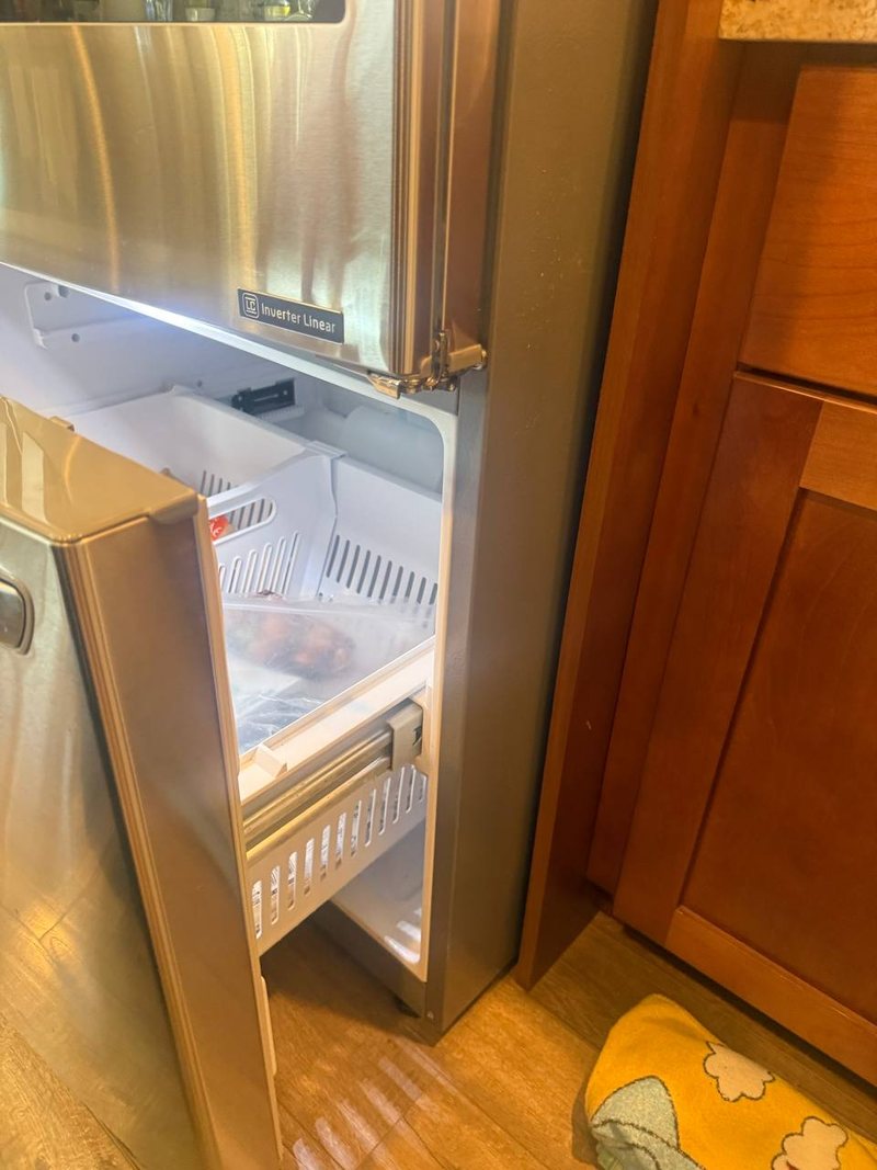 LG bottom freezer drawer open for an evaporator and defrost check
