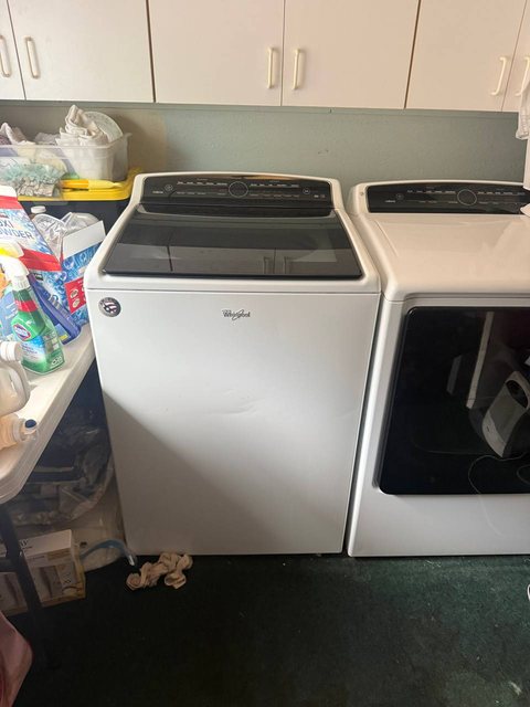 Whirlpool Cabrio top-load washer and dryer pair in a peninsula laundry room